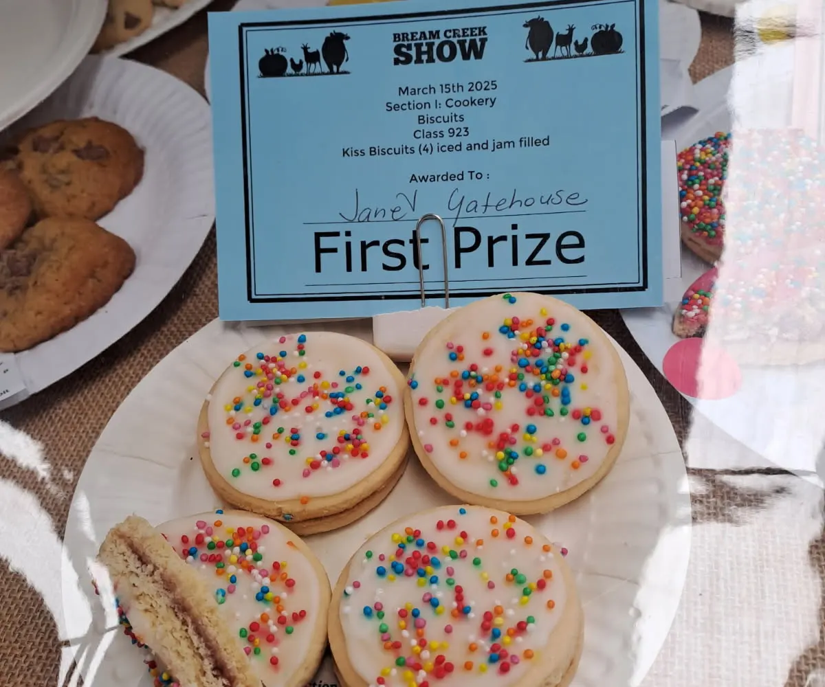 A plate of iced kiss biscuits under a Bream Creek Show first prize card made out to Janet Gatehouse